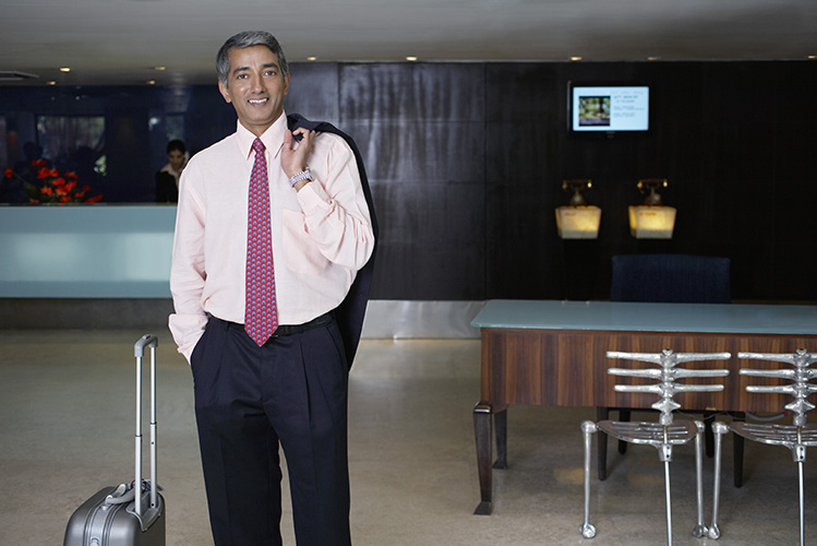 Business man standing in hotel lobby