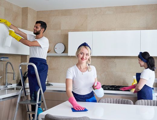 Cleaning service team at work in kitchen in private home