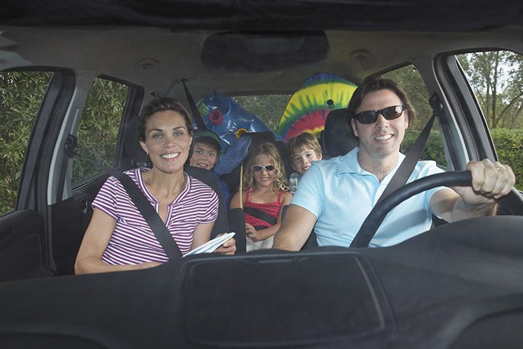 Family with 3 children in car roadtrip vacation