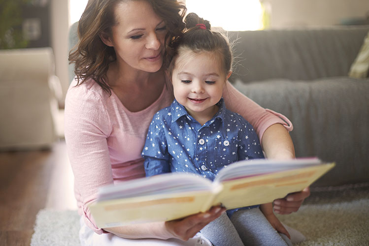 mother reading a book to her child