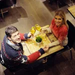 romantic evening date in restaurant happy young couple with wine glass
