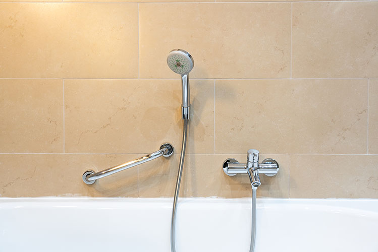 shower and handrail for elderly people at the bathroom