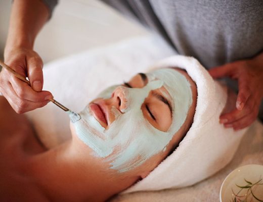 Beautician, client and mask at beauty salon for face cleansing