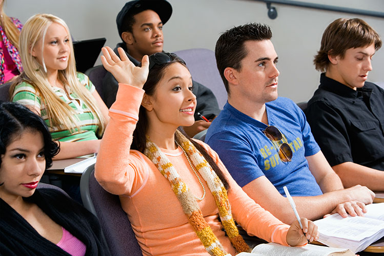 students in class raising hand