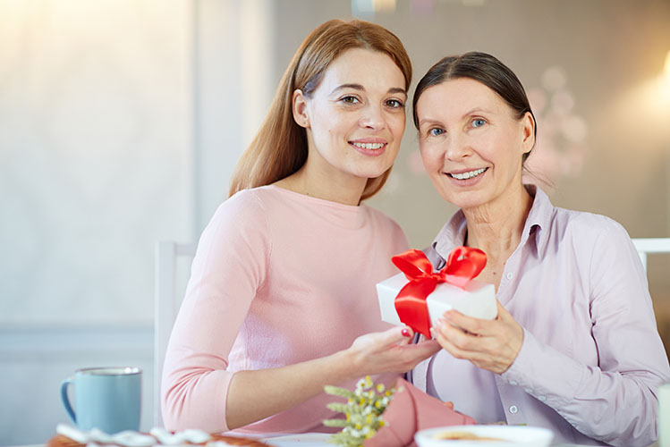woman offering gift to her mother